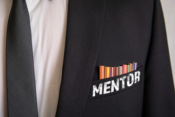 Mentor. Businessman in suit and colored pencils in chest pocket