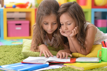Fototapeta premium two beautiful little girls studying