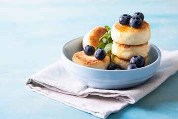 Cottage cheese pancakes. Cheesecakes from cottage cheese, delicious Breakfast, traditional Russian sweet pancakes. With blueberry, mint and honey