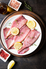 fresh squids octopus or cuttlefish for cooked food. Fresh raw cuttlefish. Raw squid with lemon. Top view and copy space for your text.