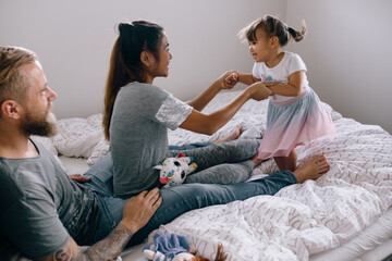 Family having fun in the bedroom