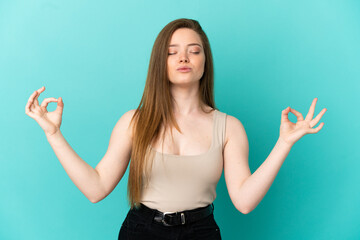Fototapeta na wymiar Teenager girl over isolated blue background in zen pose