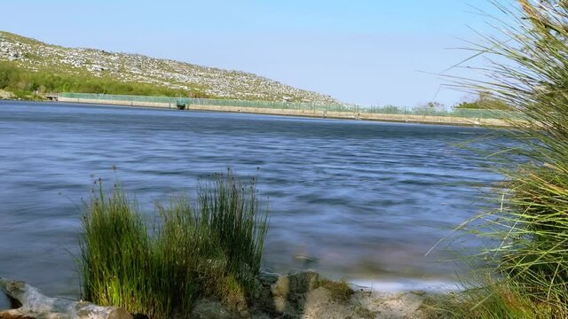 Timelapse over a dam in the late afternoon