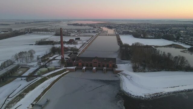 Netherlands in morning with old water pumping station in Friesland