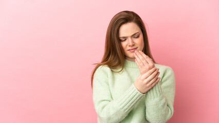 Teenager girl over isolated pink background suffering from pain in hands