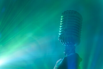 Singer holding retro microphone. Live performance or karaoke concept.