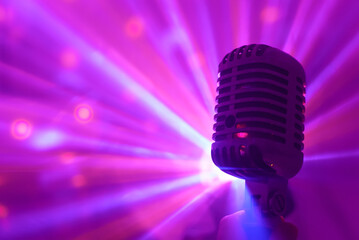 Fototapeta na wymiar Singer holding retro microphone. Live performance or karaoke concept.
