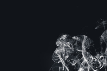 White smoke creating abstract shapes on a black background