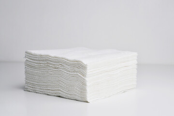 White square bar napkins isolated. Stack of clean paper tissues on white background. Stack of new white folded towels.