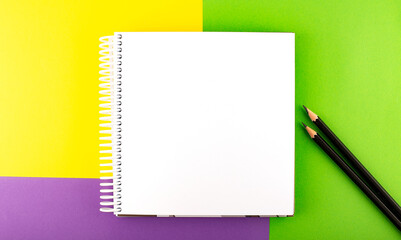 Minimal work space : sketchbook on the colorful background. Top view , flat lay