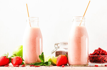 Healthy blended diet smoothie drink with strawberry and goji berries, chia seeds and lime. Glass...