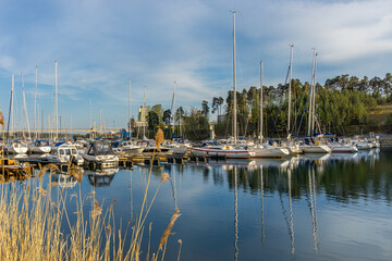 Fototapeta na wymiar A bay with moored sailboats and boats before the summer season in Sweden