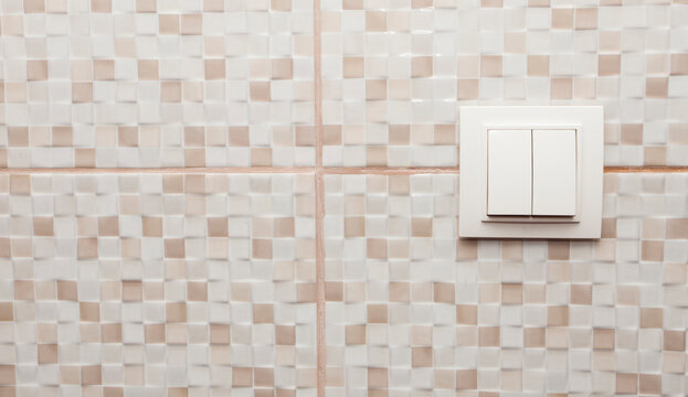 light swich on bathroom tile wall