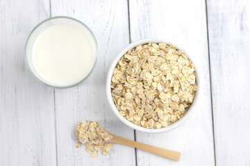 Top view of a glass of homemade fresh milk made from oatmeal. Vegetable alternative milk. Ideal for vegetarians