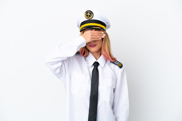 Airplane pilot over isolated white background covering eyes by hands. Do not want to see something