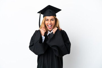 Young university graduate over isolated white background celebrating a victory in winner position