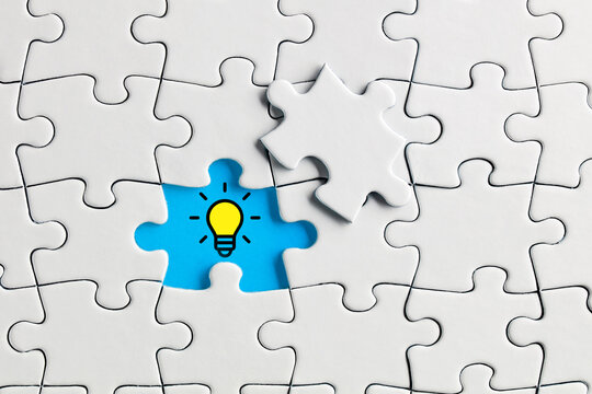 Idea or creativity light bulb icon on the missing puzzle piece. To find a creative solution