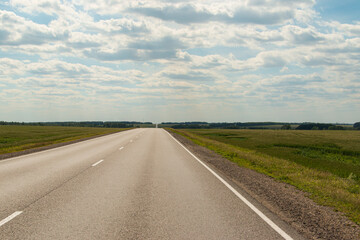 landscape with blue sky and with green field and road