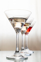 cocktail or champagne glasses on a warm beige background. concept for a beverage bar, vertical photo