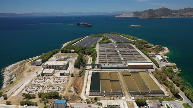 Aerial drone video of latest technology sewage and sludge processing plant in small island of Psitalia or Psyttaleia, Piraeus, Attica, Greece