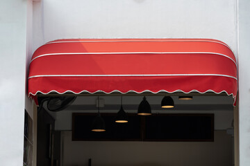 red curve awning of shop. red canvas roof.