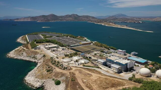 Aerial drone video of latest technology sewage and sludge processing plant in small island of Psitalia or Psyttaleia, Piraeus, Attica, Greece