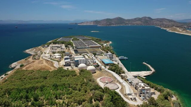 Aerial drone video of latest technology sewage and sludge processing plant in small island of Psitalia or Psyttaleia, Piraeus, Attica, Greece