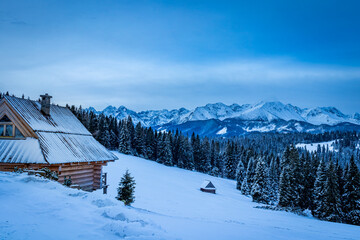 wooden house  with high mountain panorama in the winter 