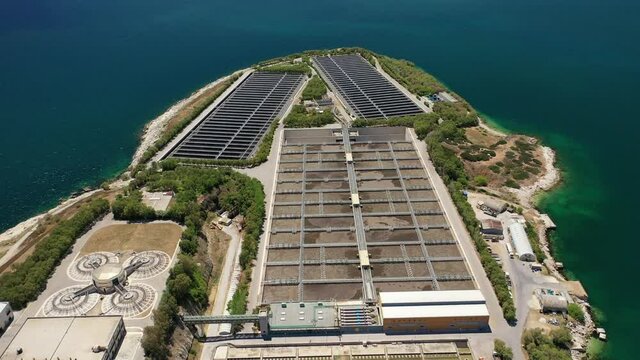 Aerial drone video of latest technology sewage and sludge processing plant in small island of Psitalia or Psyttaleia, Piraeus, Attica, Greece