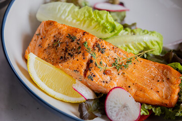 Grilled salmon fish with lemon and vegetables mix