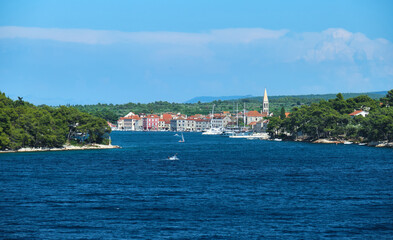Fototapeta na wymiar The old town Starigrad shot from the ferry in its famous bay. The oldest City of the lavender island Hvar Croatia