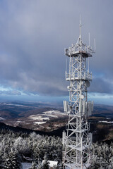 high antenna mast in mountain in winter, beautiful landscape