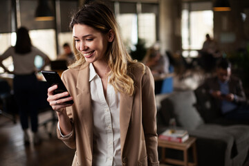 Businesswoman in office. Smiling businesswoman using the phone..