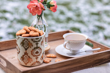 Tea and cookies in snow forest