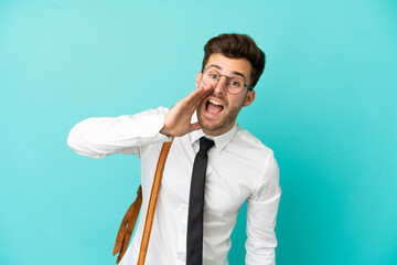 Business man over isolated background shouting with mouth wide open