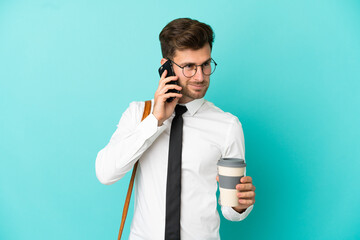 Business man over isolated background holding coffee to take away and a mobile