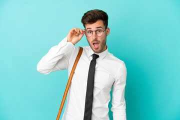 Business man over isolated background with glasses and surprised