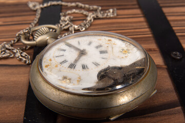 Old clock, beautiful details of an old clock on rustic wooden surface, selective focus.