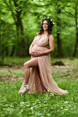 Beautiful latino pregnant woman in the forest