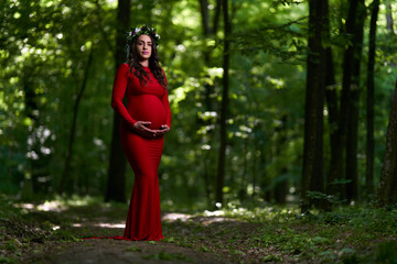 Obraz na płótnie Canvas Beautiful latino pregnant woman in the forest