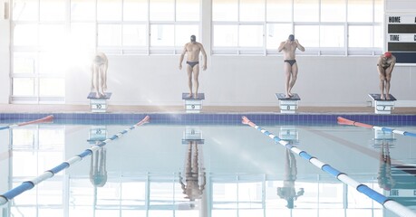 Composition of men getting ready to jump into swimming pool