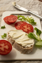 Sandwiches with cream cheese and tomatoes on the white board