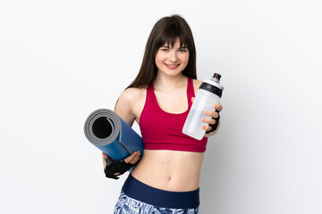 Young sport woman isolated on white background with sports water bottle and with a mat