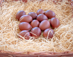 Easter eggs, painted with natural dye, wrapped in onion skins and laid out in a wicker basket