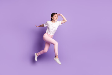 Fototapeta na wymiar Full body profile side photo of young girl happy positive smile jump run look ahead sale isolated over violet color background