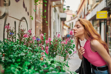 Girl taking off mask and smelling flowers