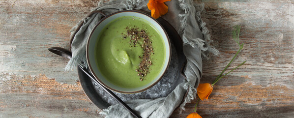 bowl with creamy broccoli soup on wooden table