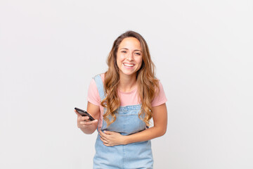 pretty woman laughing out loud at some hilarious joke and holding a smartphone