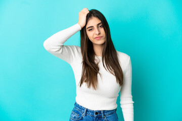 Young caucasian woman isolated on blue background with an expression of frustration and not understanding