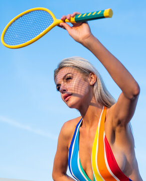 fit woman with sexy body in striped swimsuit play tennis with racket, tennis